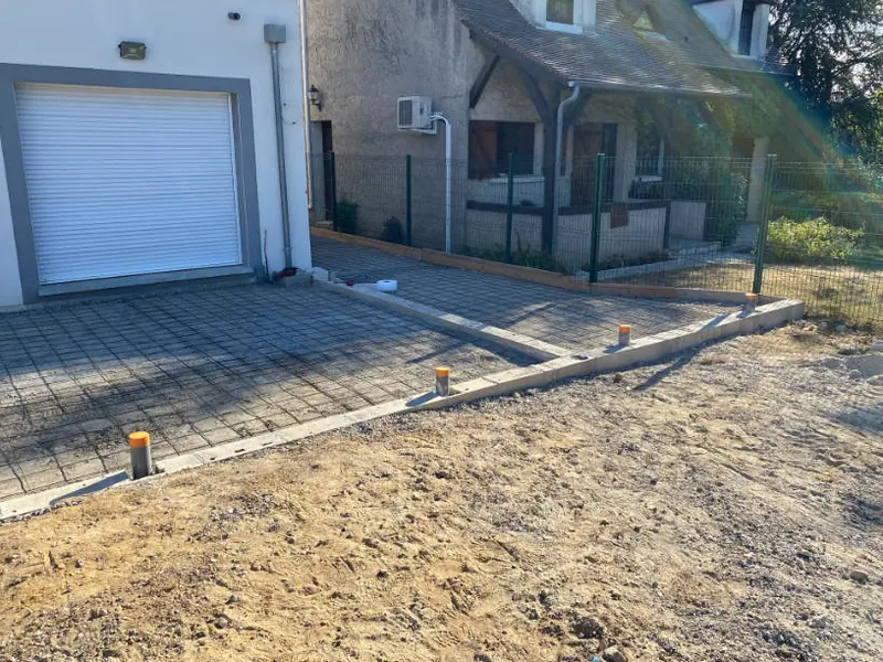 Cour terrassée pour le passage des réseaux devant un garage